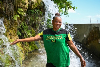 Annecia Lawson enjoys the cool waters of Roselle Falls in St. Thomas, where she has been operating a snack shop for several years.