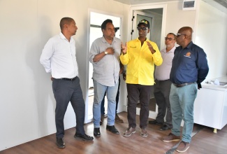 Minister of Local Government and Community Development, Hon. Desmond McKenzie (centre), makes a point during a tour of the new Trelawny Infirmary location in Falmouth on Thursday (February 26). Listening (from left) are: State Minister, Hon. Delroy Williams; Chief Technical Director in the Ministry, Dwight Wilson; Chief Executive Officer of the Trelawny Municipal Corporation, Andrew Harrison (partially hidden); and Mayor of Falmouth, Councillor Collen Gager.