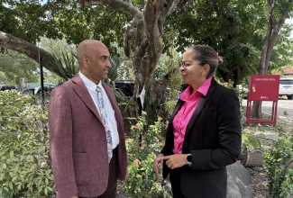 Chief Executive Officer, Environmental Foundation of Jamaica (EFJ), Nicole Adamson (left), is in conversation with Resident Representative, United Nations Development Programme (UNDP) Multi Country Office in Jamaica, Dr. Kishan Khoday following the signing of a Memorandum of Understanding (MOU) between the entities at Liguanea Club in New Kingston on Thursday (March 19).