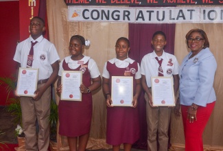 Principal of the Independence City Primary School in St. Catherine, Anne Geddes-Spence (right), shares a photo opportunity with student leaders (from left) Deputy Head Boy, Javoy Palmer; Deputy Head Girl, Jade Brown; Head Girl, Nickayla Baker; and Head Boy, Andrew Pusey. Occasion was the annual Evening of Excellence Awards Ceremony held at the school grounds in Portmore.