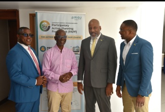 Minister of Local Government & Community Development, Hon. Desmond McKenzie (second left), in conversation with Director General of the Planning Institute of Jamaica (PIOJ), Dr. Wayne Henry (second right); Social Development Commission (SDC) Executive Director, Omar Frith (right) and SDC Board Chairman, Hidran McKulsky. The interaction took place at the Kingston & St. Andrew Governance Conference at the Jamaica Conference Centre in Kingston on Wednesday (March 25).

