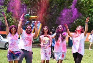 Patrons enjoying the festivities at the annual Holi festival held on the grounds of Hope Gardens in St. Andrew on Sunday (March 8).