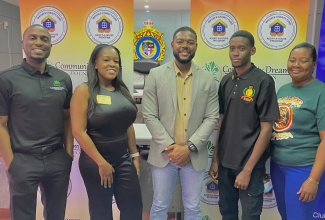 Mayor of Montego Bay, Councillor Richard Vernon (centre), shares a moment with partners of the Adopt-a-House Programme  —Chief Executive Officer of the Community Dreams Foundation (CDF), Dion Richardson (left); and Vice President of the  Montego Bay Rotary Club, Amber-Gayle Grandison (second left), along with beneficiaries Jherron Hylton and Karen Smith, following the launch ceremony at the St. James Municipal Corporation in February.
