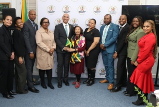 Jamaica’s Ambassador to the United States, Major General (Ret’d) Antony Anderson (fifth left), and VP Records co-founder, Patricia “Miss Pat” Chin (centre), share a light moment with members of the Embassy of Jamaica staff after she was honoured at the Embassy’s inaugural Reggae Night on February 26 in Washington DC, in celebration of Reggae Month.

