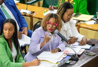 Minister of Education, Skills, Youth and Information, Senator Dr. the Hon. Dana Morris Dixon (centre), addresses Friday’s (March 6) meeting of the Standing Finance Committee of the House of Representatives, whose members reviewed the 2026/27 Estimates of Expenditure. She is joined by (from left) State Minister, Hon. Rhoda Moy Crawford; and Permanent Secretary, Dr. Kasan Troupe.  


