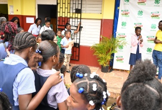Jamaica 4-H Clubs Manager for St. Ann, Tedroy Gordon (front right), looks on as Brown’s Town Primary School’s Kimone Linton, renders a cultural item during the St. Ann 4-H Clubs Parish Selection Day 2026 held at the institution on March 19.

