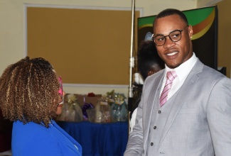 Minister of Education, Skills, Youth and Information, Senator Dr. the Hon. Dana Morris Dixon, greets with former ward of the State, Anthony Harriott, during the Child Protection and Family Services Agency (CPFSA) 14th Annual Educational Achievement Awards Ceremony at the Terra Nova All-Suite Hotel in Kingston earlier this year.

