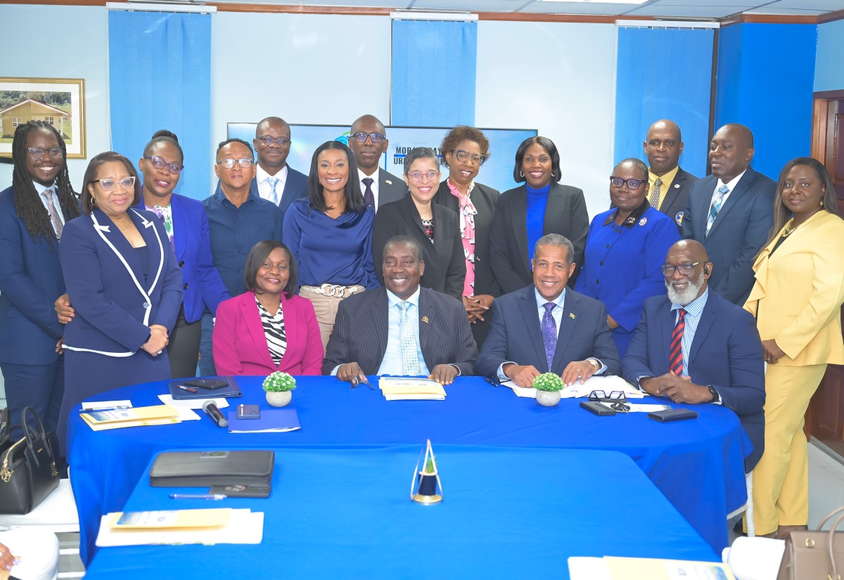 Minister without Portfolio in the Ministry of Economic Growth and Infrastructure Development, with the Responsibility for Land Titling and Settlements, Hon. Robert Montague (second left, seated), Permanent Secretary in the Ministry, Arlene Williams (left, seated), Chairman of Morant Bay Urban Centre Limited, Lyttleton Shirley (second right, seated), and Managing Director of the Factories Corporation of Jamaica, Donald Farquharson (right, seated), share a photo opportunity with representatives of government departments and agencies that have signed lease agreements to occupy spaces at the Morant Bay Urban Centre. The signing ceremony was held at the Ministry’s offices in Kingston on Thursday (March 5).

