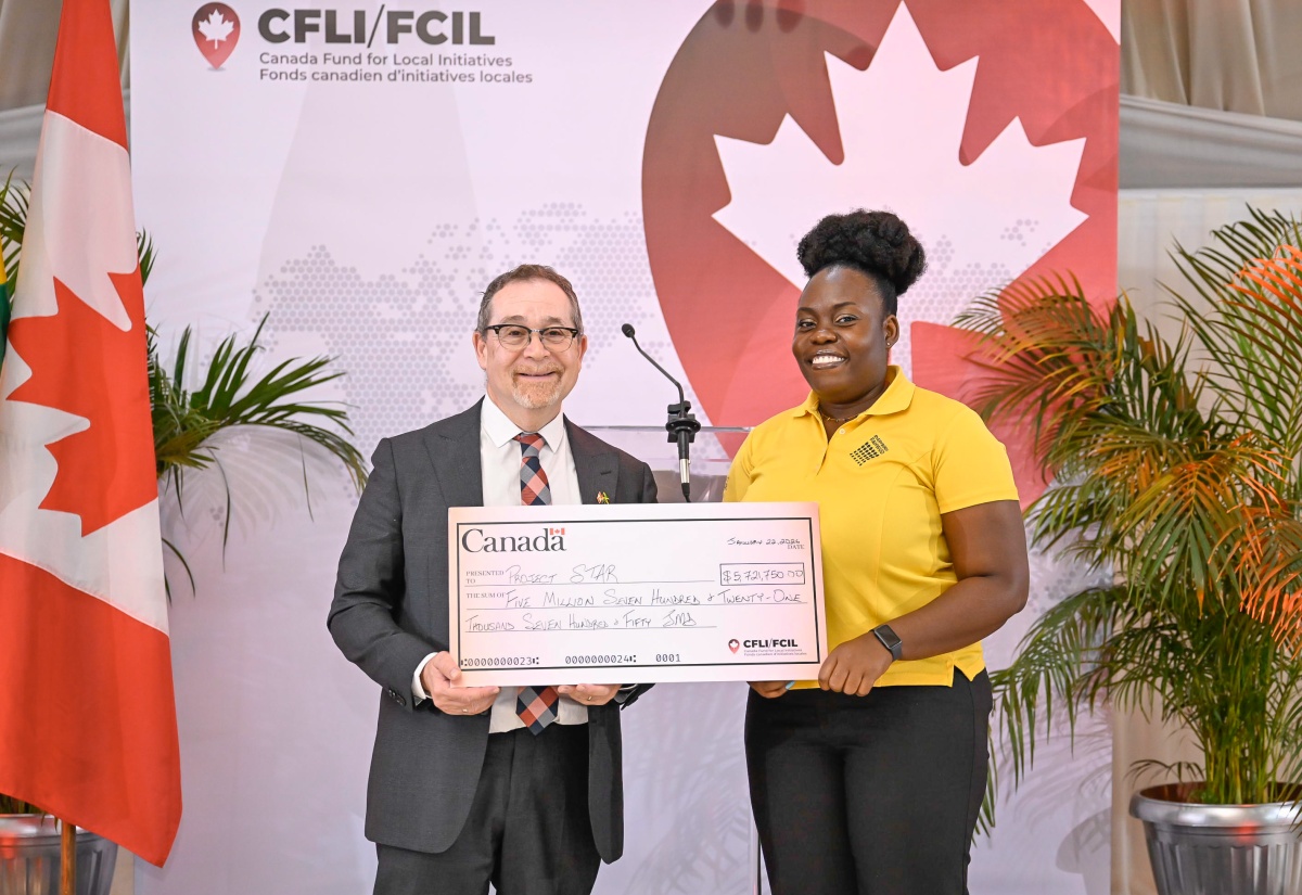 Project STAR, Coordinator, Myshka Allen, receives a cheque from High Commissioner of Canada to Jamaica, His Excellency Mark Berman, during a Canada Fund for Local Initiatives (CFLI) Spotlight Event held at the Terra Nova All-Suite Hotel in St. Andrew in January.
