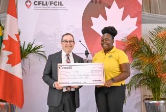 Project STAR, Coordinator, Myshka Allen, receives a cheque from High Commissioner of Canada to Jamaica, His Excellency Mark Berman, during a Canada Fund for Local Initiatives (CFLI) Spotlight Event held at the Terra Nova All-Suite Hotel in St. Andrew in January.