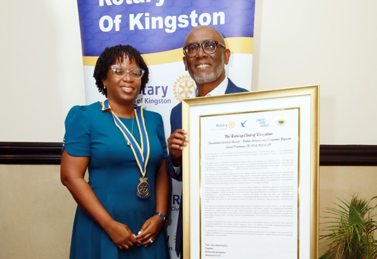 Chairman of the National Housing Trust (NHT), Linval Freeman, proudly displays the citation presented by the Rotary Club of Kingston in recognition of his exemplary leadership, sound financial stewardship, and unwavering service to Jamaica. Sharing in the moment is Rotary Club President Tricia Ann Smith DaSilva (left). The award was presented on January 29, during a ceremony held at The Jamaica Pegasus hotel in New Kingston.

