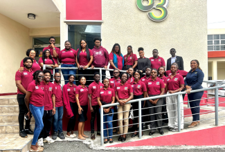 Special Projects Officer at the Jamaica Information Service (JIS), Romona Geohaghan (front row, right), shares a photo opportunity with students from the Department of Communication Studies at the Northern Caribbean University (NCU) in Mandeville outside the JIS Television Department, following a recent tour of the agency's production departments.