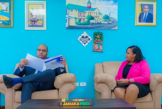 Minister of State in the Ministry of Industry, Investment and Commerce, Hon. Delano Seiveright (left), meets with Government Trustee, Elece Campbell, at his New Kingston office recently, for discussions on strengthening insolvency services.