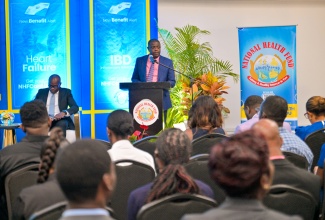 Chief Executive Officer of the National Health Fund (NHF), Everton Anderson (at podium), addresses the recent launch of the NHF’s expansion of health benefits, at the Spanish Court Hotel in St. Andrew.

