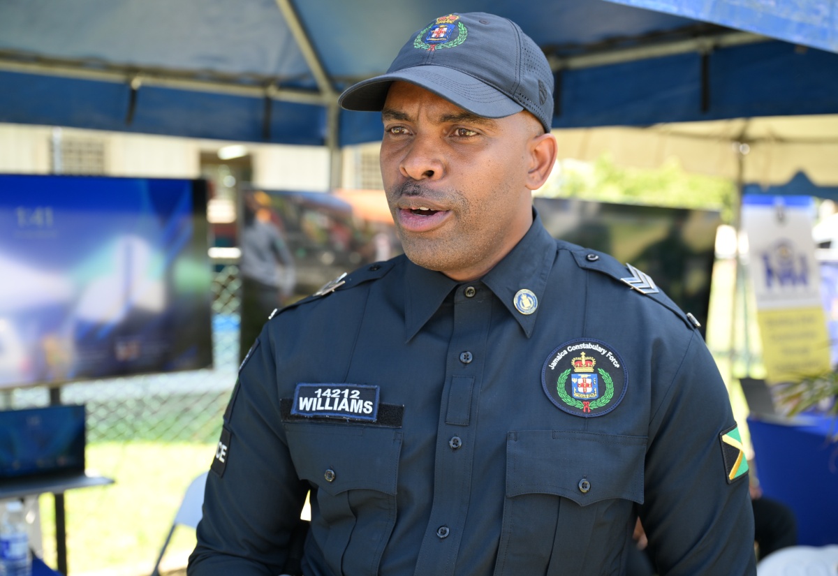 Sergeant Andrew Williams of the Community Safety and Security Branch of the Jamaica Constabulary Force (JCF) speaks to JIS News during a Youth Opportunities Exposition at the Paul Bogle Vocational Training Institute in St. Thomas on Thursday (March 26).