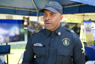 Sergeant Andrew Williams of the Community Safety and Security Branch of the Jamaica Constabulary Force (JCF) speaks to JIS News during a Youth Opportunities Exposition at the Paul Bogle Vocational Training Institute in St. Thomas on Thursday (March 26).