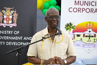 Minister of Local Government and Community Development, Hon. Desmond McKenzie, delivers the main address during the opening of the St. Thomas Night Shelter on March 27.