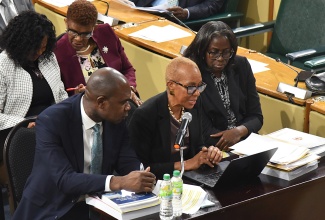 Minister of Finance and the Public Service, Hon. Fayval Williams (centre), fields questions during the Standing Finance Committee of the House of Representatives meeting at Gordon House on March 5. The Committee is examining the 2026/27 Estimates of Expenditure. Listening are Minister of State in the Ministry, Hon. Zavia Mayne, and Financial Secretary, Darlene Morrison (right). 

