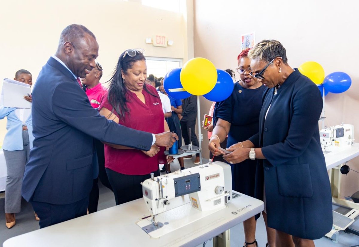 State Minister in the Ministry of National Security and Peace, Hon. Juliet Cuthbert-Flynn (right), threads a sewing machine in the new sewing lab at the South Camp Juvenile Correctional and Remand Centre in Kingston, through assistance from Chief Technical Director in the Ministry, Shauna Trowers. Looking on (from left) are Commissioner of Corrections, Department of Correctional Services (DCS), Brigadier (Ret’d) Radgh Mason, and Chief Executive Officer, Digicel Foundation, Charmaine Daniels.

