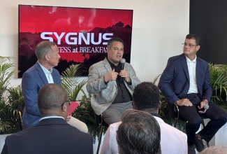 Minister of Water, Environment and Climate Change, Hon. Matthew Samuda (centre), participates in a panel discussion during the Sygnus Business at Breakfast event held at the company