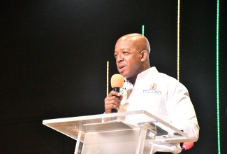 Minister of Labour and Social Security, Hon. Pearnel Charles Jr., delivers remarks during the Trelawny leg of the Restoration of Owner or Occupant Family Shelters (ROOFS) Programme handover ceremony, held at Abundant Life Ministries Church in Bounty Hall on March 11.