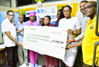 Head of Oncology at Cornwall Regional Hospital (CRH), Dr. Harvey Crawford (left), and Regional Clinical Coordinator at CRH, Dr. Delroy Fray (second left), accept a cheque for US$20,000 from Healthcare Ecosystem Partner at Roche Pharmaceuticals, Jermaine Spence (second right). The occasion was a handover ceremony held at the facility on Friday (March 27). Joining them (from third left) are Oncology Nurse at CRH, Nurse Melissa Winder; Acting Manager, Oncology Department at CRH, Nurse Keisha Shaw;  Oncologist, CRH, Dr. Jodie Taylor-Graham; Oncology Nurse at CRH, Cameal Johnson;  Manager, Nephrology Department at CRH, Nurse Leset Stephenson, and Director of Pharmacy Services, at the National Health Fund (NHF), Western, Clive Harris.
