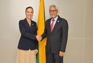 Minister of Foreign Affairs and Foreign Trade, Senator the Hon. Kamina Johnson Smith (left), greets Secretary-General of the International Federation of Red Cross and Red Crescent Societies (IFRC), Jagan Chapagain, during a courtesy call on Tuesday (April 21) at the Ministry, downtown Kingston.
