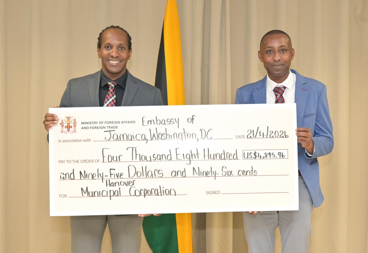 State Minister in the Ministry of Foreign Affairs and Foreign Trade, Hon. Alando Terrelonge (left), and Chief Financial Officer of the Hanover Municipal Corporation, Romeo Daley, display a cheque donated by the Jamaican Diaspora to benefit the Hanover Infirmary. The presentation took place on Tuesday (April 21) at the Ministry in downtown Kingston.

