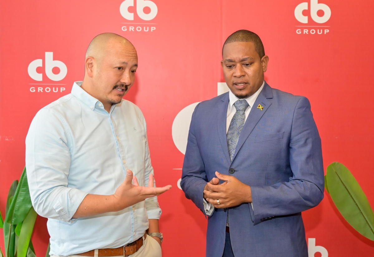 Minister of Agriculture, Fisheries and Mining, Hon. Floyd Green (right), engages with CB Group Chief Executive Officer (CEO), Mattew Lyn (left), during the launch of the poultry company’s ‘The Time is Now’ campaign held on Wednesday (April 22) at Jamaica Food and Drink Kitchen in Kingston. 
