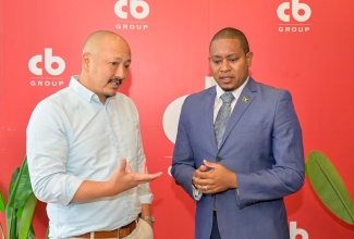 Minister of Agriculture, Fisheries and Mining, Hon. Floyd Green (right), engages with CB Group Chief Executive Officer (CEO), Mattew Lyn (left), during the launch of the poultry company’s ‘The Time is Now’ campaign held on Wednesday (April 22) at Jamaica Food and Drink Kitchen in Kingston.