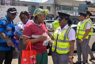 Transport Authority (TA) Route Inspectors engage members of the public on Friday (April 24), during the launch of the organisation’s Behavioural Change Campaign —