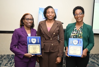 Acting Government Archivist at the Jamaica Archives and Records Department (JARD), Ketanya Laing (centre), shares a photo opportunity with (from left) Document Services Manager at the Passport, Immigration and Citizenship Agency (PICA), Althea Moore; and Head of Administration at the Information and Communications Technology (ICT) Authority, Fern Townsend, during Monday’s (April 20) Records Information Management (RIM) Implementation Programme Offboarding Ceremony, held at The Jamaica Pegasus hotel in New Kingston.
