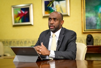 Senior Deputy Governor, Bank of Jamaica, Dr. Wayne Robinson, emphasises a point during an interview with JIS News on April 1.
