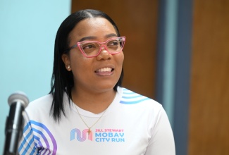 Past beneficiary of the Jill Stewart MoBay City Run scholarship, Shanique Corbett, speaks during a Jamaica Information Service (JIS) 