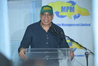 Prime Minister, Dr. the Most Hon.  Andrew Holness, addresses the Olympic Court Housing Development community meeting at the complex