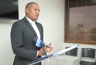 Minister of Agriculture, Fisheries and Mining, Hon. Floyd Green, delivers the keynote address during the symbolic cheque handover ceremony for the Jamaica Network of Rural Women Producers (JNRWP) Roots Resilience Parametric Insurance Programme, held on Monday (March 9) at the GK General Insurance office in New Kingston.


