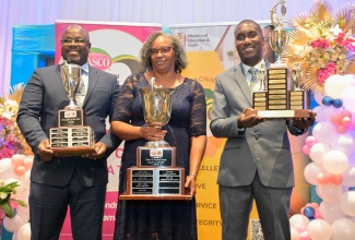 LASCO/Ministry of Education, Skills, Youth and Information/Jamaica Teaching Council 2025 Teacher of the Year, Dorette Rhoden-Henry, shares the spotlight with Principal of the Year, Orville Richards (left), and Technical and Vocational Education and Training (TVET) Teacher of the Year, Gavin DeRizzio, during the awards ceremony at the Jamaica Pegasus Hotel in New Kingston on March 25.