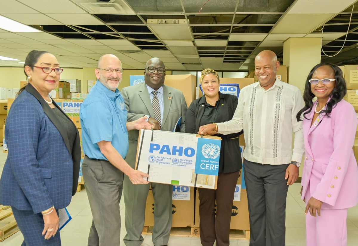 State Minister in the Ministry of Health and Wellness, Hon. Krystal Lee (third right), receives Inter-Agency Reproductive Health (IARH) Kits and Dignity Kits during the handover ceremony on Wednesday (April 1) at the United Nations Population Fund (UNFPA) Warehouse in downtown Kingston. Sharing the moment are (from left) International Pan American Health Organisation (PAHO) Consultant, Health Emergencies (Caribbean), Dr. Marion Bullock DuCasse; PAHO/World Health Organisation (WHO) Representative for Jamaica, Bermuda and the Cayman Islands, Ian Stein; United Nations (UN) Resident Coordinator for Jamaica, Bermuda, Cayman Islands and Turks and Caicos, Dennis Zulu; Director and Representative of UNFPA, Harold Robinson; and National Maternal and Neonatal Health Coordinator and Public Health Specialist, Ministry of Health, Dr. Carol Lord.