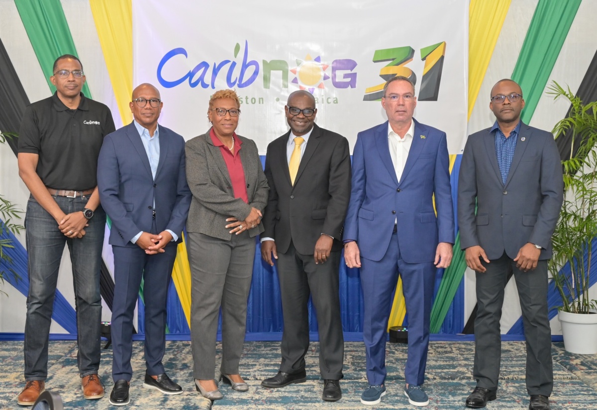Minister of Energy, Transport and Telecommunications, Hon. Daryl Vaz (second right), shares lens with (from left) Chief Executive Officer (CEO) of Arkitechs Inc., Stephen Lee; Chairman of Caribbean Datacentre Association, Giovanni King; Director of Research and Stakeholder Engagement at Caribbean Network Operators Group (CaribNOG), Dr. Claire Craig; Director General of the Office of Utilities Regulation (OUR), Ansord Hewitt; and CaribNOG Co-founder, Bevil Wooding, during the 31st  staging of the CaribNOG Forum, held on Tuesday (April 14) at The Jamaica Pegasus hotel in New Kingston. 

