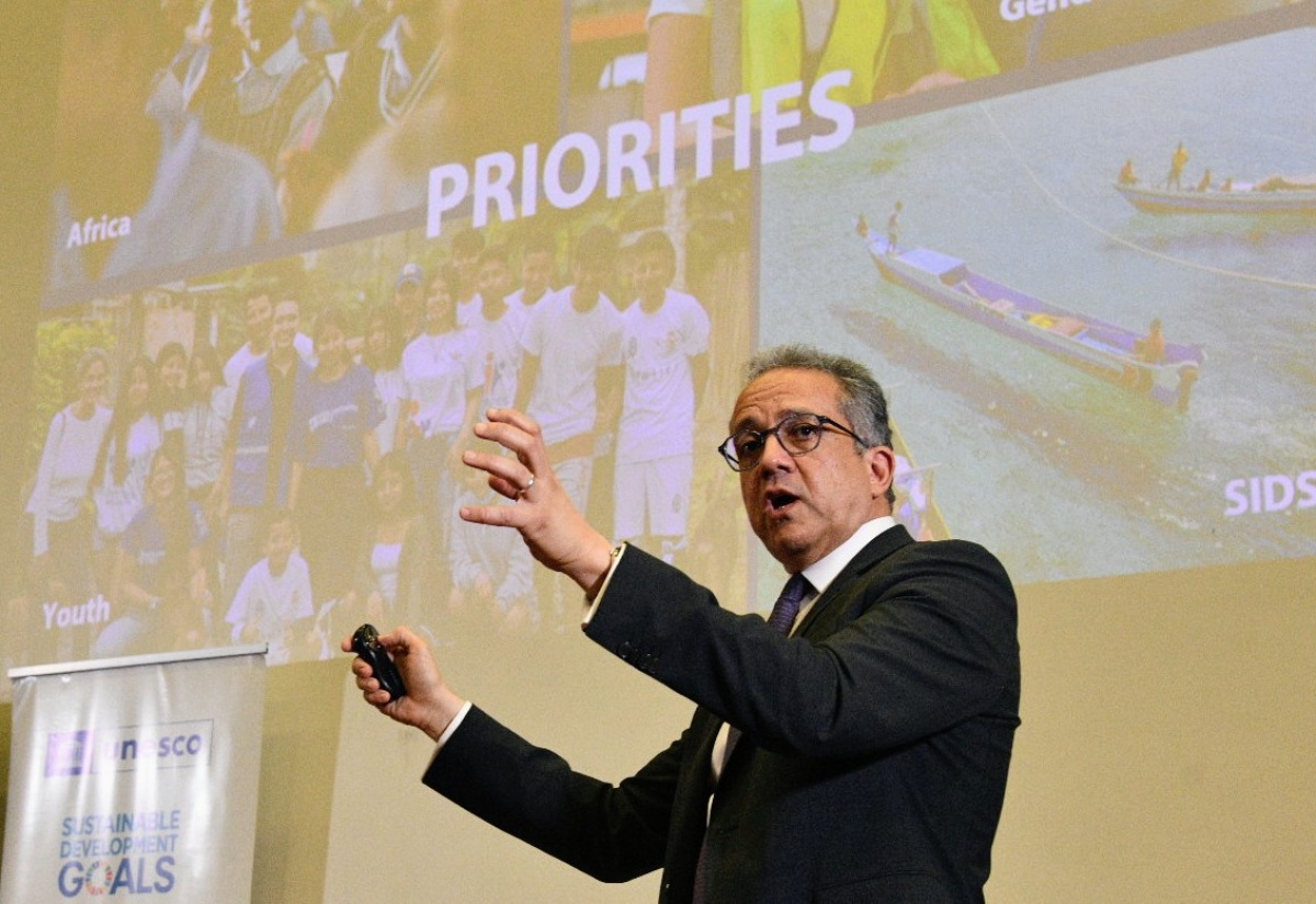 Senior Lecturer at the University of the West Indies (UWI), Mona, Dr. Marvadeen Singh-Wilmot (left), presents a gift to Director General of the United Nations Educational, Scientific and Cultural Organization (UNESCO), Professor Khaled El-Enany, following his public lecture at the St. Andrew based campus, on Thursday (April 2). 