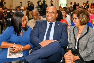 Minister of State in the Ministry of Industry, Investment and Commerce, Hon. Delano Seiveright, shares a light moment with Chief Executive Officer, Cannabis Licensing Authority (CLA), Farrah Blake (left), and Permanent Secretary in the Ministry,  Sancia Bennett Templer, during the launch of CLA's Medical Cannabis Special Permit Programmes at the AC Hotel by Marriott Kingston on Thursday (April 16).

