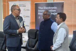 Minister of Health and Wellness, Dr. the Hon. Christopher Tufton (left), converses with Managing Director of ArguSoft America Incorporated, Ram Gopalan (centre), and President of Professional Services at Argusoft America Incorporated, Ravi Shankar, following the contract signing for the implementation of the Electric Immunisation Registry (EIR) Project on April 17. The signing ceremony was held at the Health Ministry's Emergency Operations Centre (EOC) Conference Room in New Kingston.