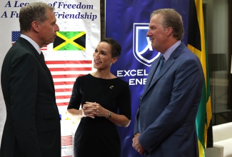 Minister of Foreign Affairs and Foreign Trade, Senator the Hon. Kamina Johnson Smith (centre), shares in conversation with President, Excelerate Energy, Steven Kobos (left), and Chargé d'Affaires, United States (US) Embassy, Scott Renner, during Excelerate Energy's first anniversary celebrations held at the residence of the US Ambassador in St. Andrew on Tuesday (April 28). 
