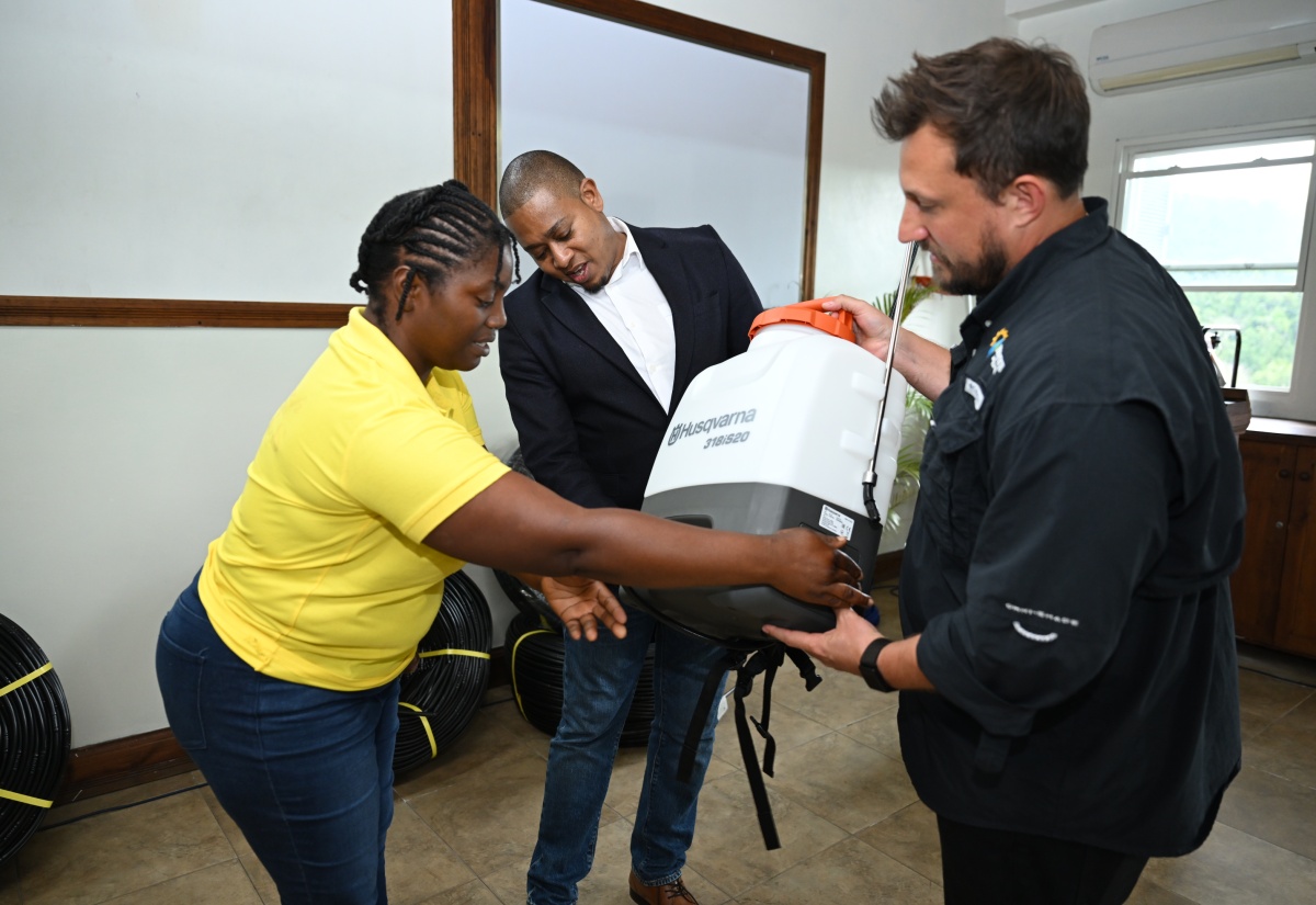 Minister of Agriculture, Fisheries and Mining, Hon. Floyd Green (centre) and Manchester farmer, Georgette Henry-Morgan (eft), examine a crop sprayer being shown to them by Chief Executive Officer of Isratech Jamaica Limited, Benjamin Hodara, during the official lunch of the Isratech Resilience Farm Tour on Wednesday (April 8), at the company’s offices in Kendal, Manchester.