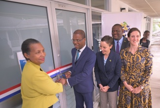Minister of Foreign Affairs and Foreign Trade, Senator the Hon. Kamina Johnson Smith (second right), and Parliamentary Secretary in the Ministry of Education, Skills, Youth and Information, Senator Marlon Morgan (background), participate in the recent opening of Alliance Française de la Jamaïque's new location at the Technology Innovation Centre (TIC) on the University of Technology (UTech) campus in Papine, St. Andrew.  Cutting the ribbon (from left) are President of Alliance Française, Jamaica, Mylene Ferriera, and President of UTech, Dr. Kevin Brown, while Ambassador of France to Jamaica, Her Excellency Marianne Ziss, looks on.

