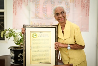 National icon, first woman surgeon in the Caribbean, and former Minister of Education, Dr. Mavis Gilmour-Petersen displays a citation from the Ministry, during a visit to her St. Andrew home, on (April 16).
