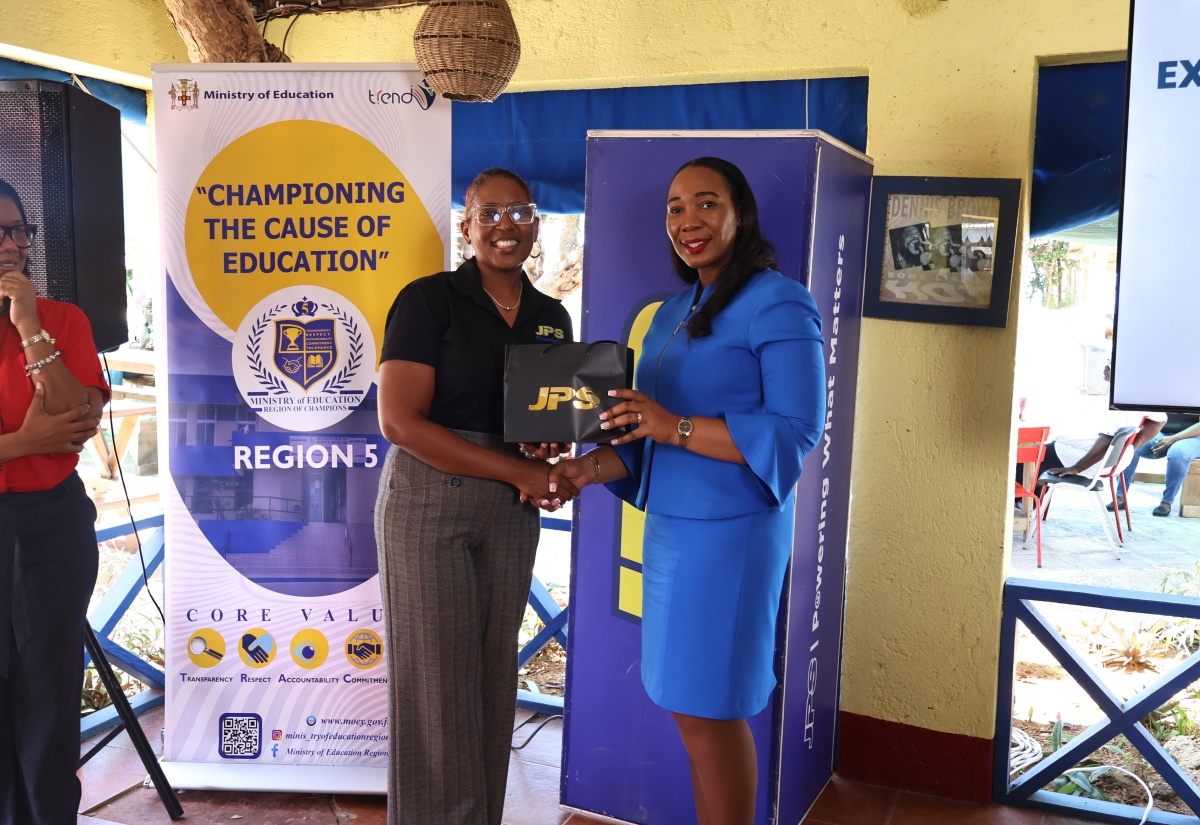 Head of the Jamaica Public Service Company (JPS) Foundation, Sophia Lewis, makes a presentation to Region Four Education Officer, Ministry of Education, Skills, Youth and Information, Dr. Patricia Mumby Lalor, at the official launch of the JPS extra lesson programme for St. Elizabeth and Westmoreland students at Jack Sprat Treasure Beach in St. Elizabeth on April 7.