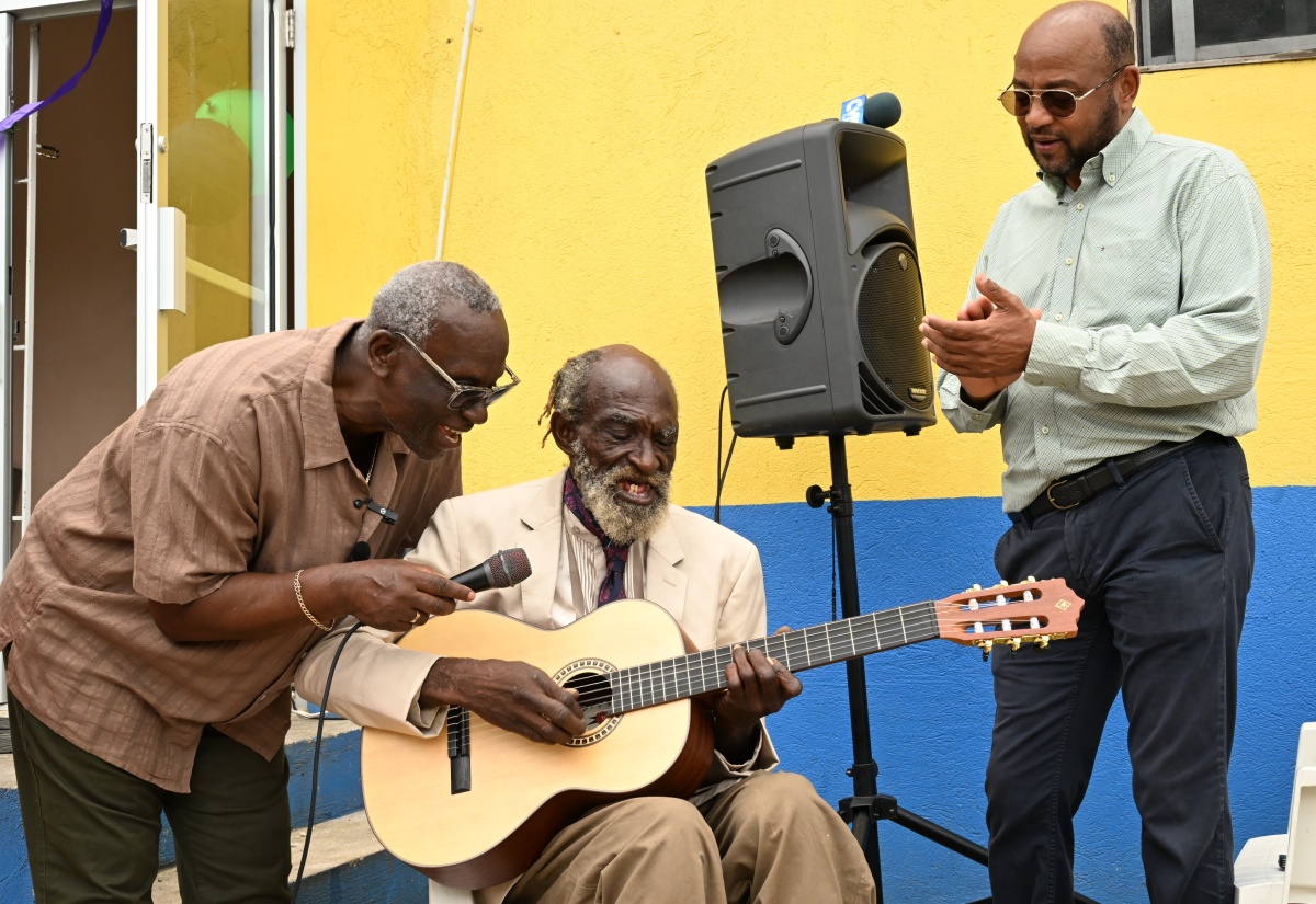 Drop-In Centre Visitor Receives Guitar from Minister