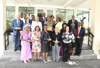 Stalwarts in the early-childhood education sector show off awards presented at the JN Foundation and University of the West Indies (UWI) School of Education Dudley Grant Early Childhood Resource Centre Awards Luncheon on Tuesday (April 14) at the JN Financial Centre in St. Andrew. They are joined by Chief Executive Officer, Jamaica National (JN) Group, Earl Jarrett (back row, centre) and Chairman, JN Foundation, Parris Lyew-Ayee (second row, left).