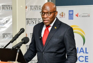 Chief Justice, Hon. Bryan Sykes, addresses the recent signing of an agreement with the Republic of Rwanda for the implementation of an Integrated Electronic Case Management System (IECMS) in Jamaica at the Ministry of Justice and Constitutional Affairs in Kingston.

